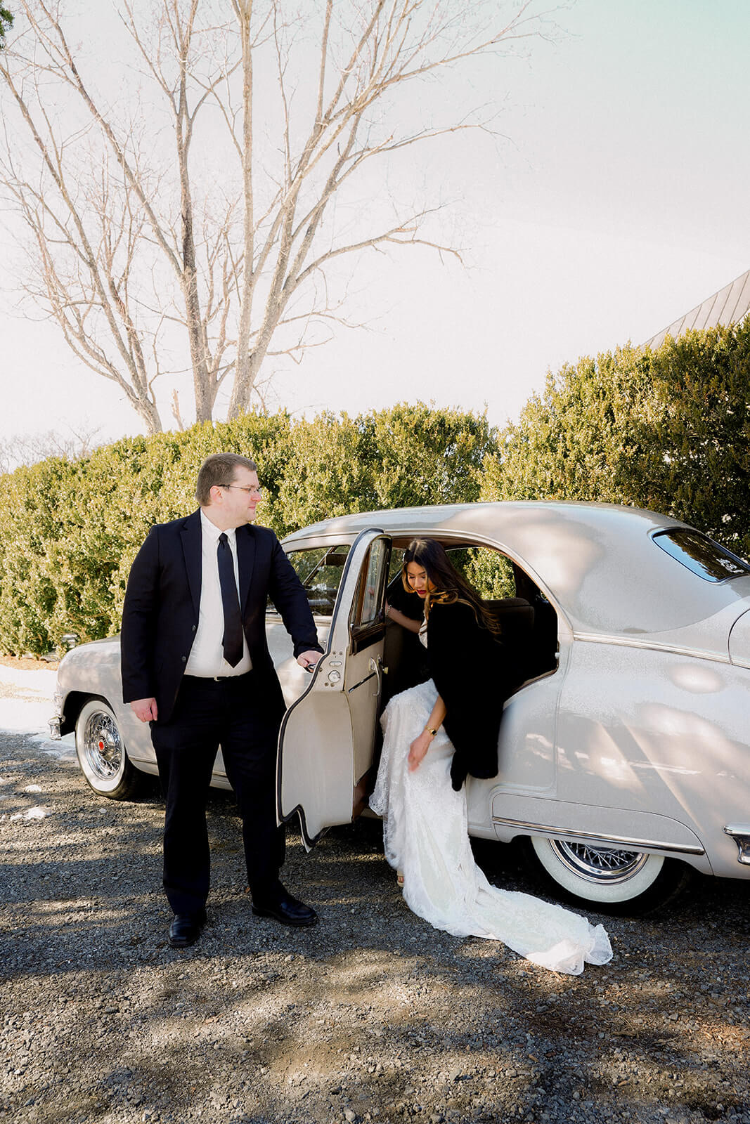 Luxury chauffeur opening door for bride arriving in vintage Packard — Classic Car Limousines Virginia