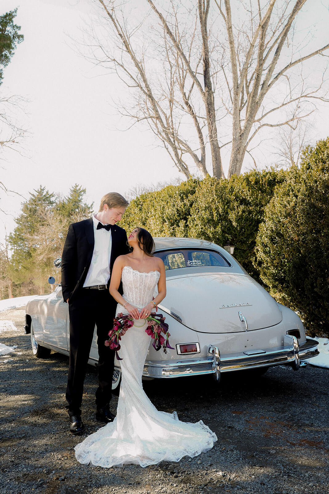 Bride and groom behind 1949 Packard vintage wedding limousine Virginia winter